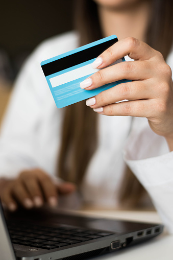 Unrecognizable female Purchasing items for the office online with credit card
