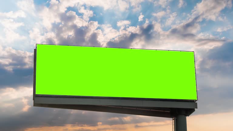 Timelapse - blank green billboard and sun beams shining through clouds at sunset