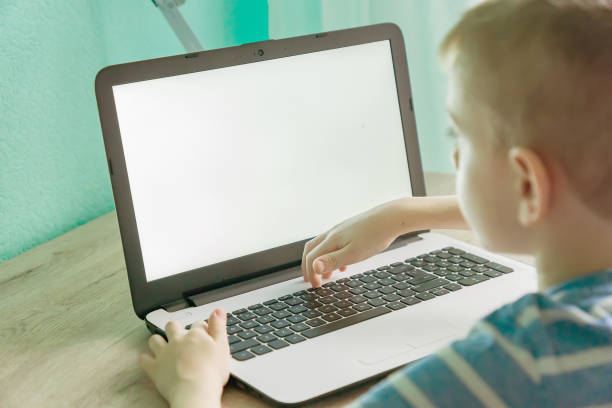 istock Distance learning online education. Schoolboy studying at home with laptop and doing school homework. 1219905741