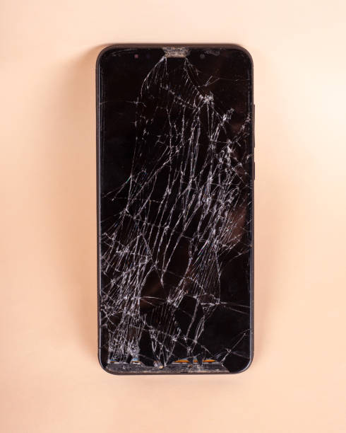 istock broken touchscreen black phone, smartphone, broken glass display smartphone on a beige background 1219907441
