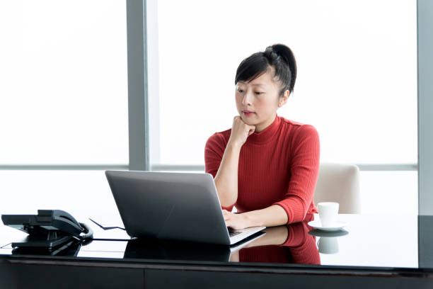 istock Woman using laptop in the office 1219907617