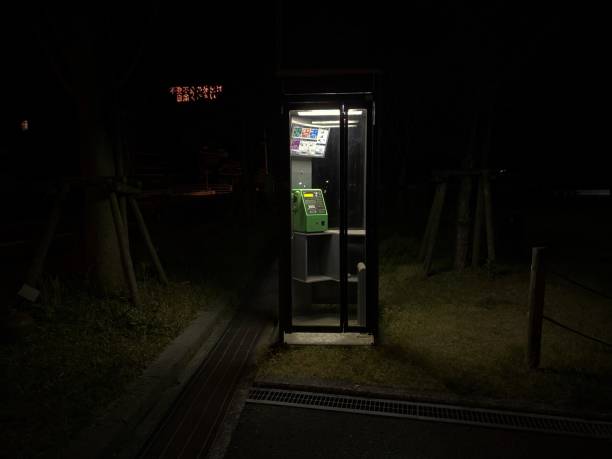 Pay phone at night This is a Japanese payphone. ghost town stock pictures, royalty-free photos & images