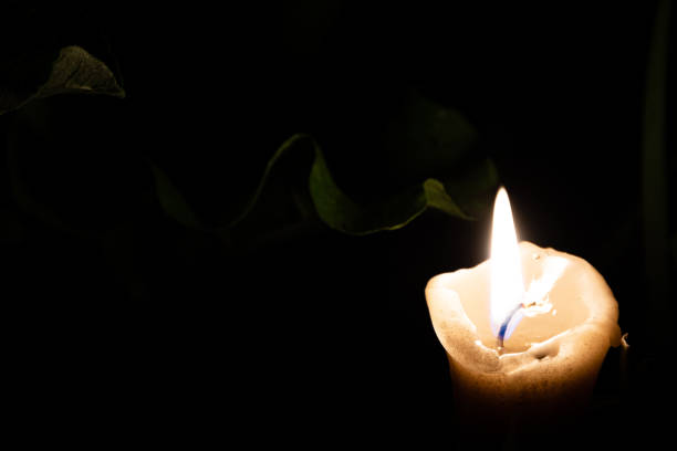 istock Solitary candle burns in summer garden at night 1219911367