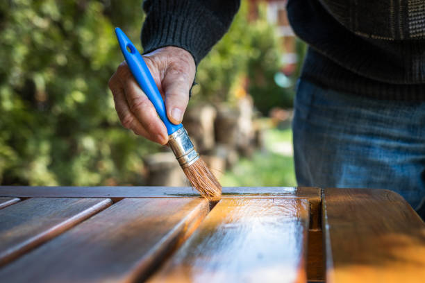 istock Craftsman painting wooden table 1219911481