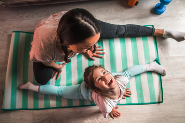 istock Mother and daughter practicing  in bedroom 1219912760