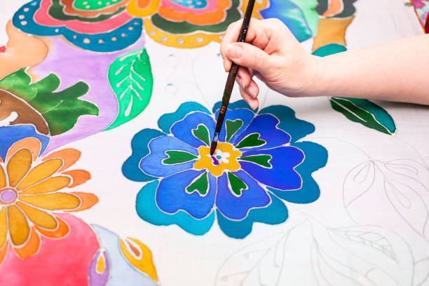 istock artist paints flower in batik on silk canvas 1219913103