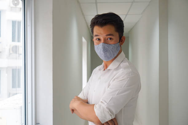 istock Asian elegant man wearing a mouth protection to prevent getting sick at work , mask protect coronavirus 1219914269