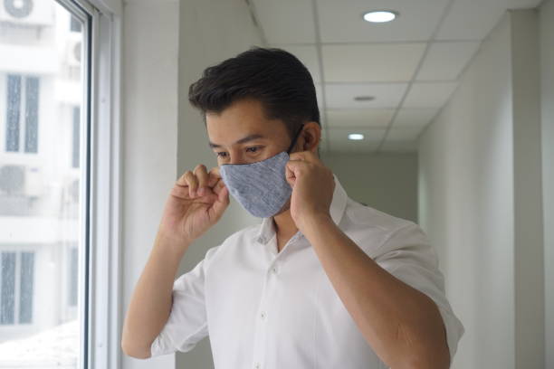 istock Asian elegant man wearing a mouth protection to prevent getting sick at work , mask protect coronavirus 1219914354