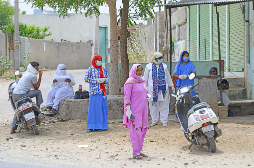 Beawar, Rajasthan, India - April 19, 2020: Anganwadi workers and medical staff wearing protective face mask at Roopnagar village during first day of curfew imposed in 28 village after COVID-19 case in Beawar.