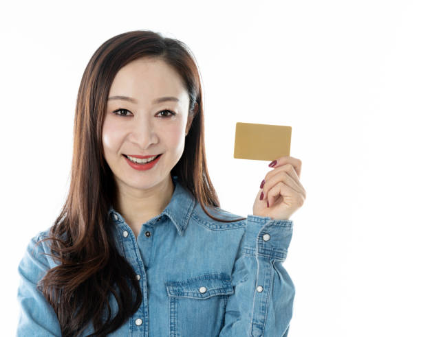 istock Woman holding credit card on white background 1219916685