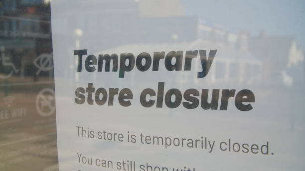 istock Closed sign in window due to Coronavirus pandemic 1219917318