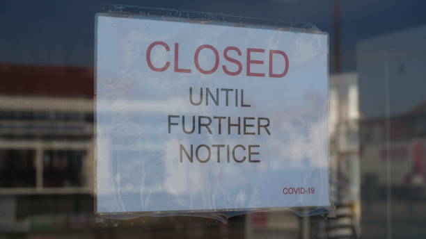 istock Closed sign in window due to Coronavirus pandemic 1219917346