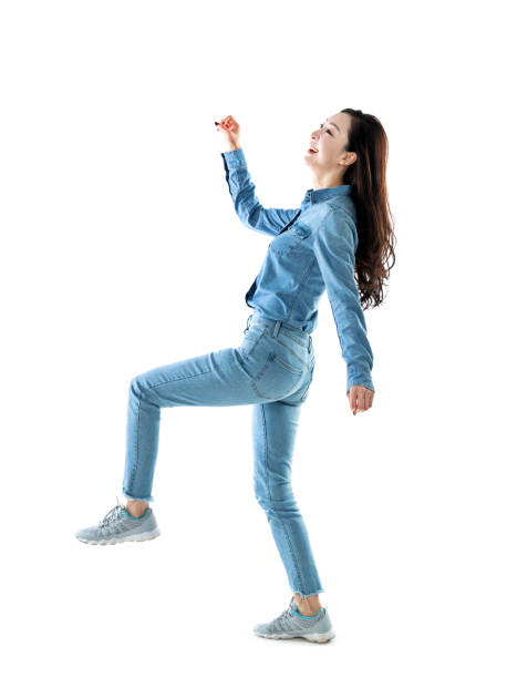 istock Excited woman jumping on white background 1219917583