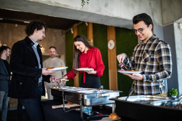 istock Coworkers taking food from chafing dish on business lunch after work 1219917622