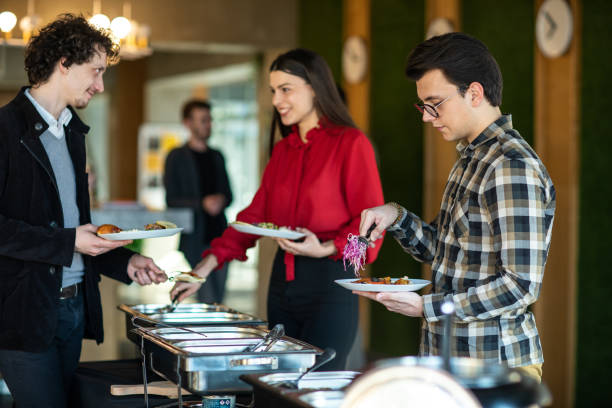 istock Colleagues serving themselves at buffet after work at self service restaurant 1219917731