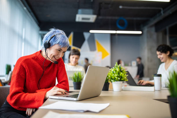 istock Young woman with headset talking with customer 1219917739