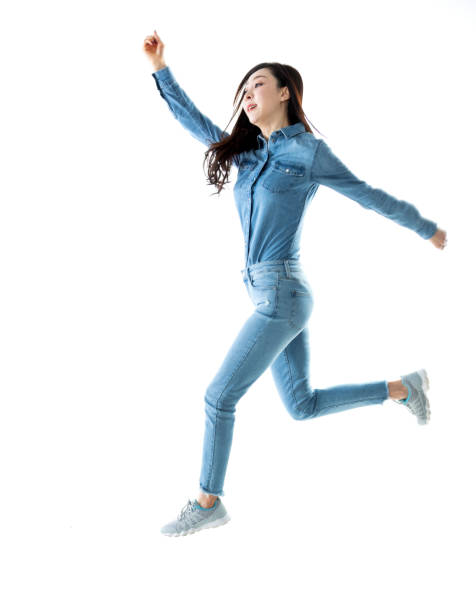 istock Excited woman jumping on white background 1219917778