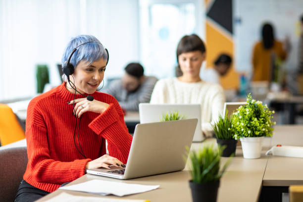 istock Young woman with headset talking with customer 1219917882