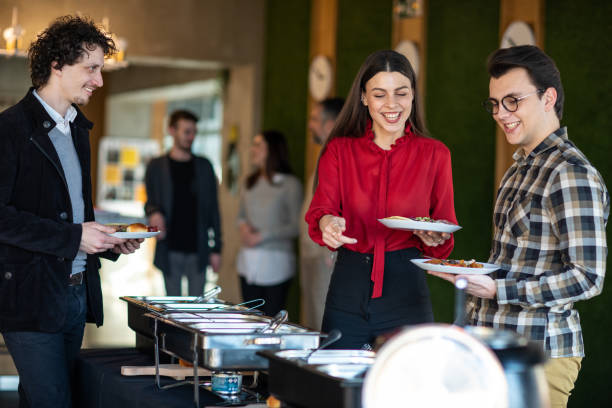 istock Happy business people serving themselves at buffet 1219917981