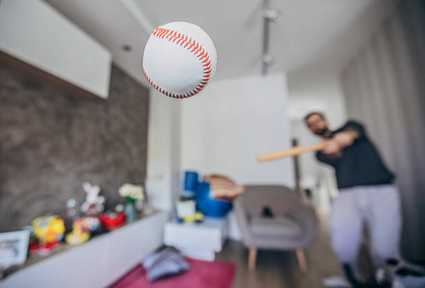 istock Man hitting baseball ball at home 1219919149
