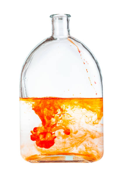 istock orange watercolour paint dissolves in glass flask 1219919248