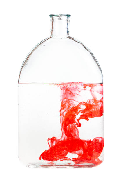 istock red watercolour dissolves in water in glass flask 1219919268