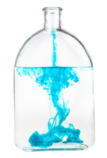 istock blue ink dissolves in water in bottle isolated 1219919294