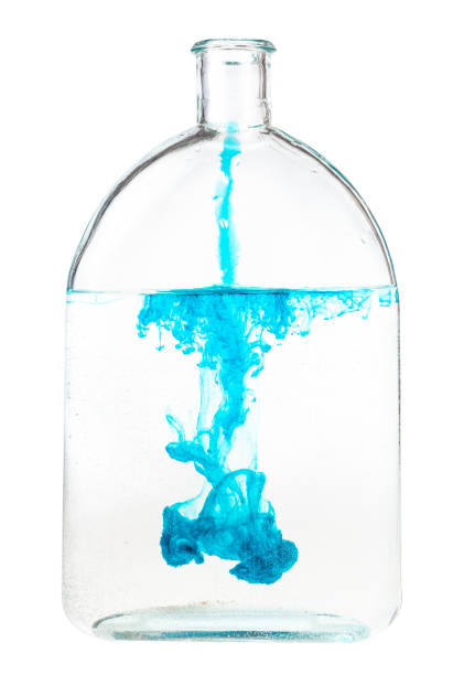 istock blue ink dissolves in water in flask isolated 1219919305