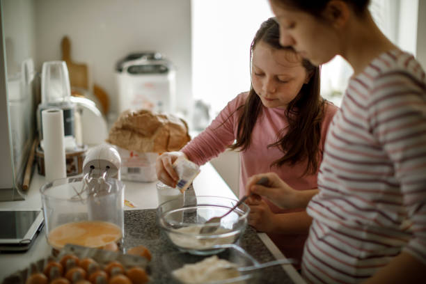 istock Sisters cooking together at home 1219919320