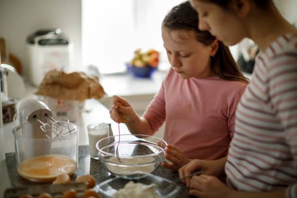 istock Sisters cooking together at home 1219919414