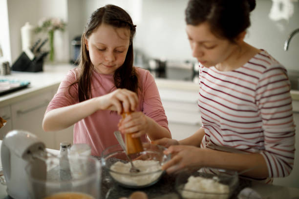 istock Sisters cooking together at home 1219919511