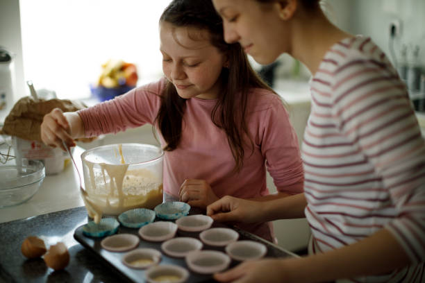 istock Sisters baking muffins at home 1219919627
