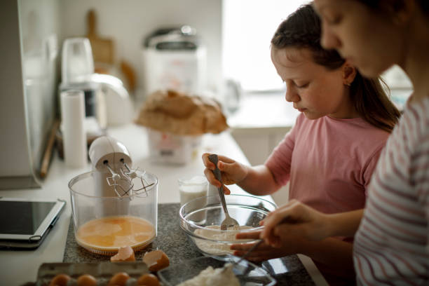 istock Sisters cooking together at home 1219920208
