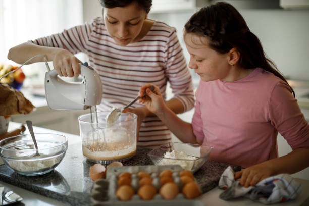 istock Sisters cooking together at home 1219920307