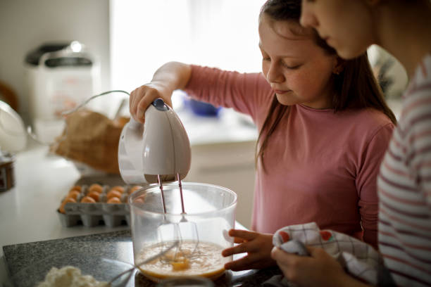 istock Sisters cooking together at home 1219920463