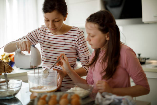 istock Sisters cooking together at home 1219920502