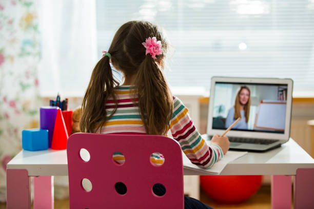 Online education and e-learning concept. Young female distance teacher having video conference call with pupil using webcam. Online education and e-learning concept. Home quarantine distance learning and working from home. homeschooling photos stock pictures, royalty-free photos & images