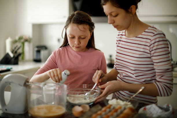 istock Sisters cooking together at home 1219920657