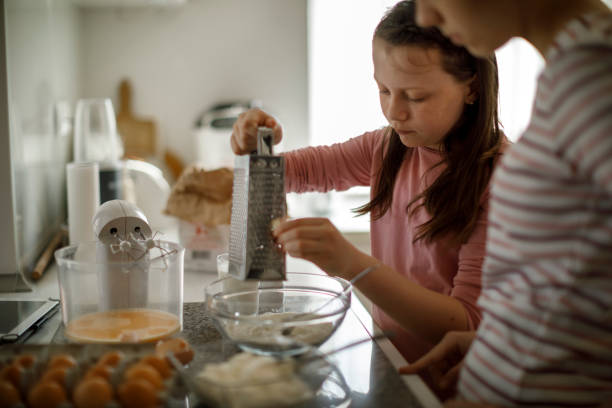 istock Sisters cooking together at home 1219920671
