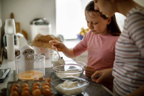 istock Sisters cooking together at home 1219920673