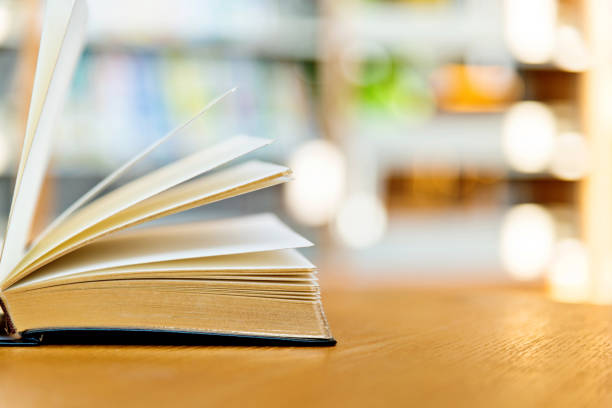 istock An open book on the table of public library 1219920844