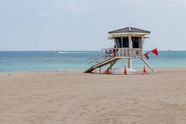 Lifeguard tower on a closed beach with motor boat stock photo