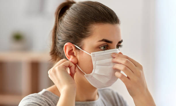istock young woman wearing protective medical face mask 1219921991