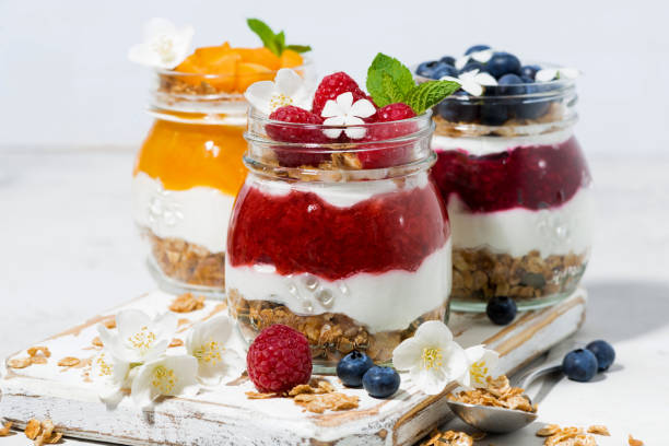 istock desserts with granola, berry and fruit puree in jars 1219923537