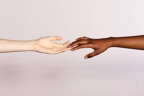 istock racism concept, black and white hand holding together 1219923673