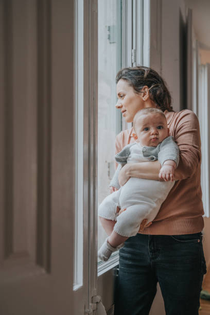 istock Mother with son looking through the window 1219926776