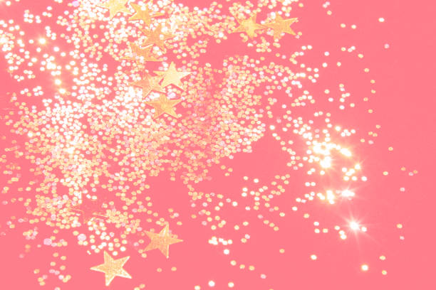 istock gold glitter confetti on a coral background 1219927774