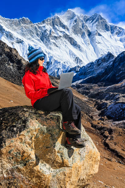 istock Young woman using laptop in Himalayas, Nepal 1219929082