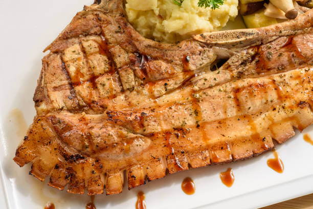 istock Grilled pork chop with mash potato and dressing 1219929115