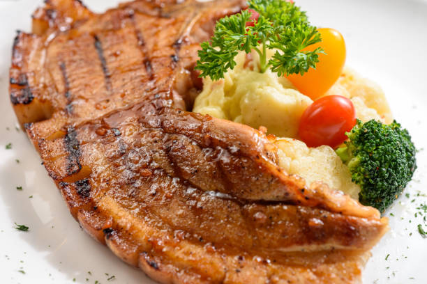 istock Grilled pork chop with mash potato and dressing 1219929159
